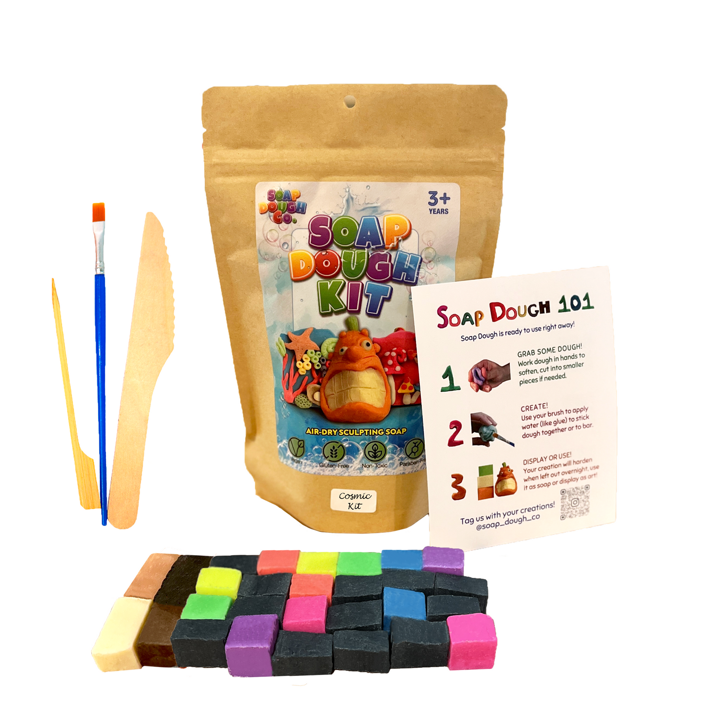Soap Dough Co. - Cosmic Kit - Wall of neon yellow, purple, green, orange, blue, and pink with majority black soap dough cubes. eco-bag, instructions, and tools next to soap dough cubes with accent colors.