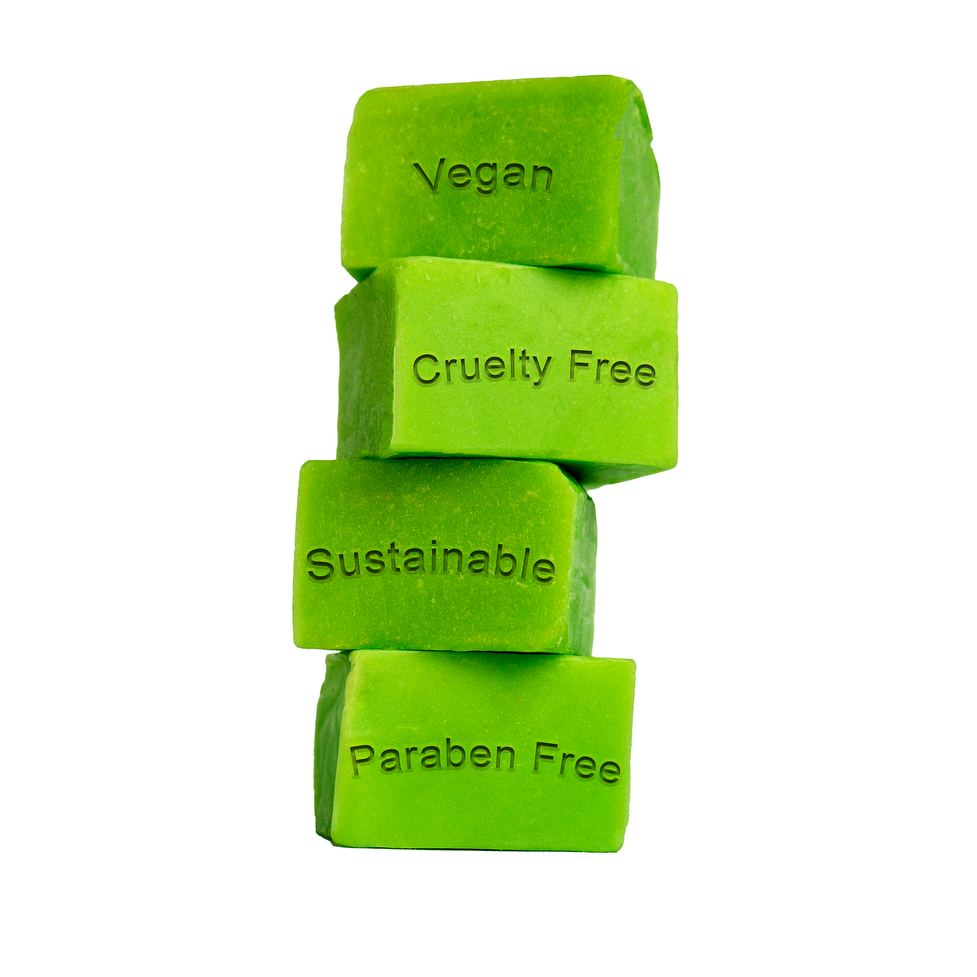 Stacked green soap dough cubes with the words "vegan, cruelty-free, sustainable, and paraben free" carved into soap dough cubes.